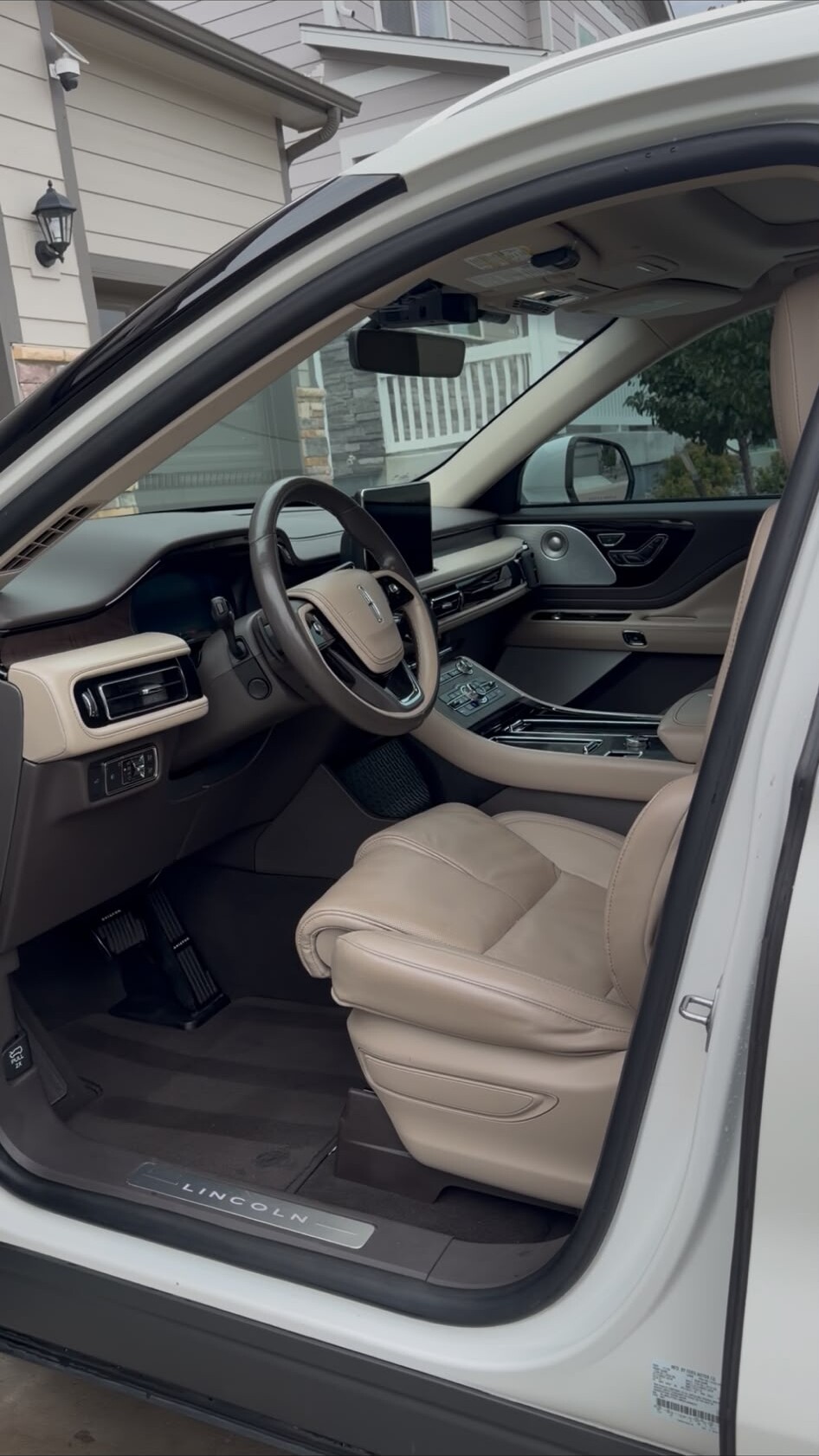 Lincoln interior with cream leather seats after detailing